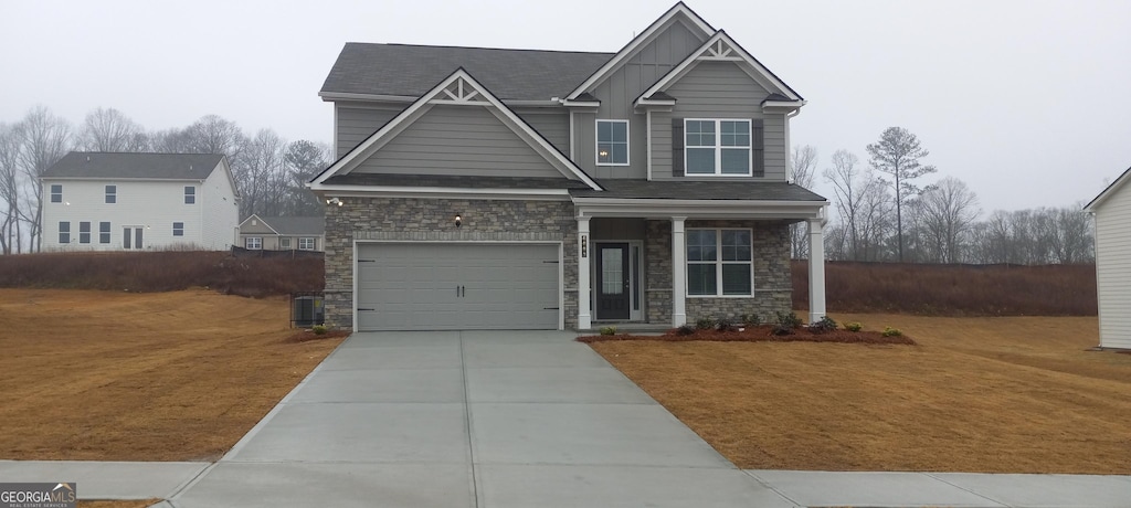 6093 Ruby Fall, Stonecrest, GA 30038 - craftsman-style home with a garage, stone siding, driveway, and a front yard