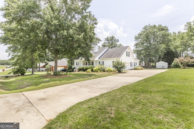 132 Hidden Creek Cir, Lizella, GA 31052 - view of front of home featuring an outdoor structure, a front yard, a detached garage, and concrete driveway