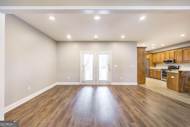 132 Hidden Creek Cir, Lizella, GA 31052 - unfurnished living room featuring wood finished floors, recessed lighting, and french doors