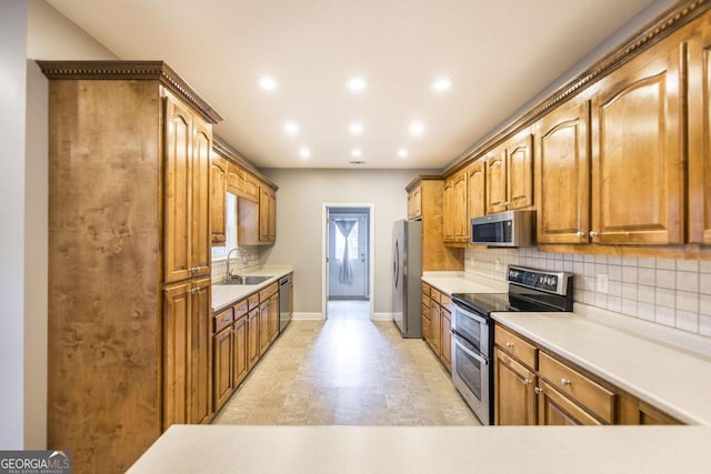 132 Hidden Creek Cir, Lizella, GA 31052 - kitchen with appliances with stainless steel finishes, backsplash, recessed lighting, brown cabinetry, and light countertops