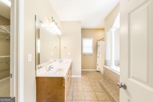 132 Hidden Creek Cir, Lizella, GA 31052 - full bathroom with double vanity, a relaxing tiled tub, a spacious closet, tile patterned floors, and a shower with shower curtain