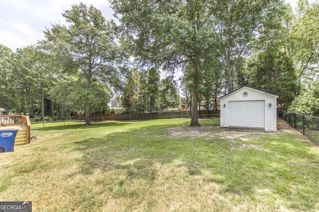 132 Hidden Creek Cir, Lizella, GA 31052 - fenced backyard with an outdoor structure, a detached garage, and view of wooded area