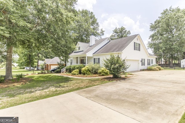 132 Hidden Creek Cir, Lizella, GA 31052 - view of side of property with concrete driveway, a garage, a chimney, and a porch
