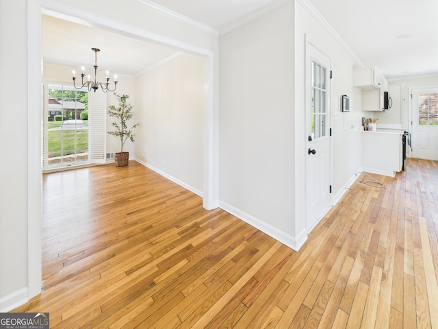 4630 Glenwood Dr, Macon, GA 31210 - corridor featuring light wood finished floors, a chandelier, plenty of natural light, and crown molding