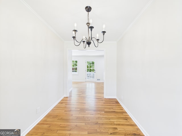 4630 Glenwood Dr, Macon, GA 31210 - unfurnished dining area featuring a chandelier, light wood-style floors, and ornamental molding