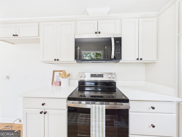 4630 Glenwood Dr, Macon, GA 31210 - kitchen featuring stainless steel appliances, light countertops, and white cabinets