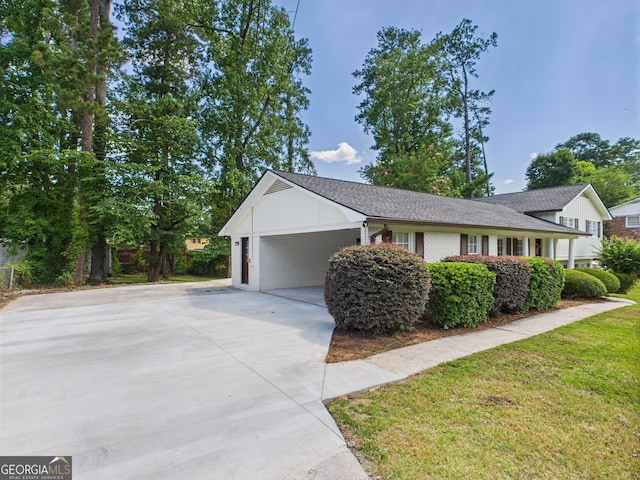 4630 Glenwood Dr, Macon, GA 31210 - view of home's exterior featuring driveway, board and batten siding, brick siding, and a carport