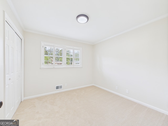 4630 Glenwood Dr, Macon, GA 31210 - unfurnished bedroom with ornamental molding, carpet flooring, and a closet