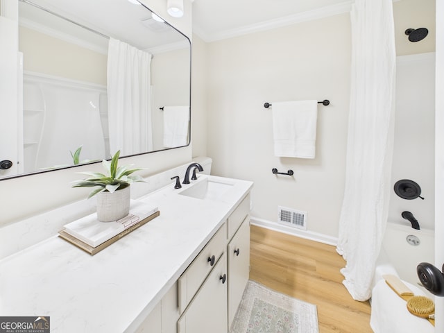4630 Glenwood Dr, Macon, GA 31210 - bathroom featuring wood finished floors, vanity, ornamental molding, and shower / bath combo with shower curtain