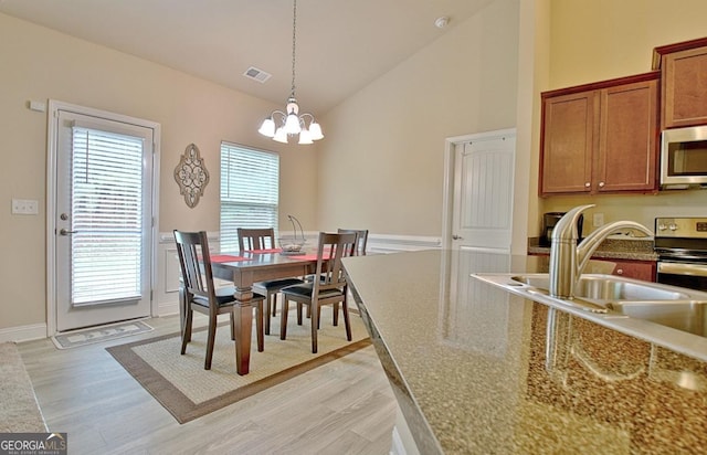 862 Crescent Ln, Griffin, GA 30224 - dining space featuring a chandelier, light wood finished floors, and high vaulted ceiling