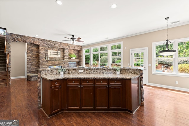 1065 Beacon Hill Xing, Alpharetta, GA 30005 - kitchen featuring ceiling fan, healthy amount of natural light, ornamental molding, dark wood finished floors, and dark brown cabinets