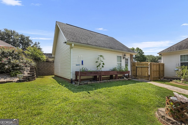 408 Dixieland Dr, Byron, GA 31008 - back of property featuring roof with shingles and a gate