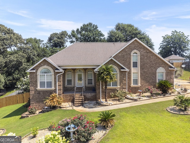 408 Dixieland Dr, Byron, GA 31008 - view of front of home featuring a porch, brick siding, and roof with shingles