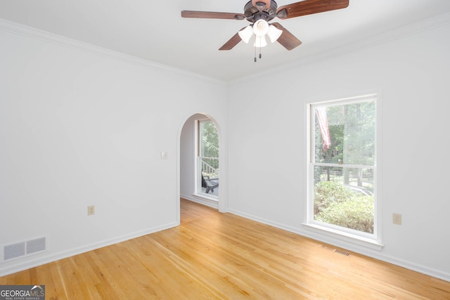 5491 Hiram Rd, Powder Springs, GA 30127 - spare room featuring light wood-style flooring, crown molding, arched walkways, and ceiling fan
