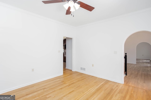 5491 Hiram Rd, Powder Springs, GA 30127 - empty room featuring arched walkways, ceiling fan, light wood finished floors, and crown molding