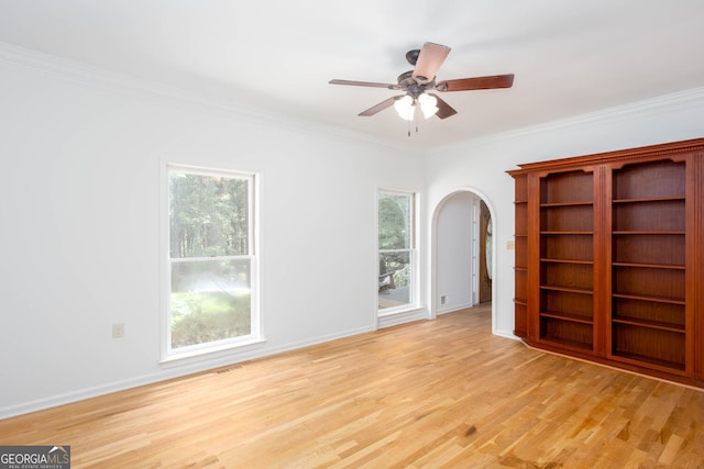 5491 Hiram Rd, Powder Springs, GA 30127 - spare room with arched walkways, light wood-style flooring, crown molding, and a ceiling fan