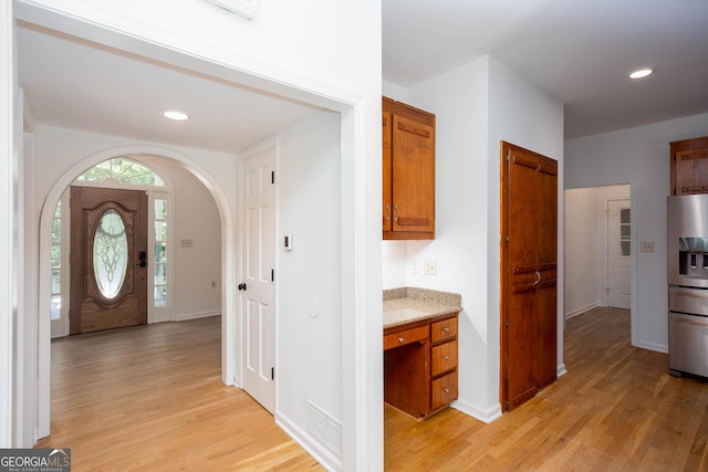 5491 Hiram Rd, Powder Springs, GA 30127 - entryway featuring arched walkways, light wood finished floors, and recessed lighting