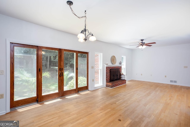 5491 Hiram Rd, Powder Springs, GA 30127 - unfurnished living room featuring plenty of natural light, light wood-style flooring, ceiling fan, and a chandelier