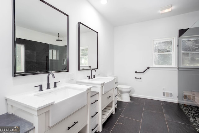 5491 Hiram Rd, Powder Springs, GA 30127 - bathroom with two vanities, a tile shower, and tile patterned floors