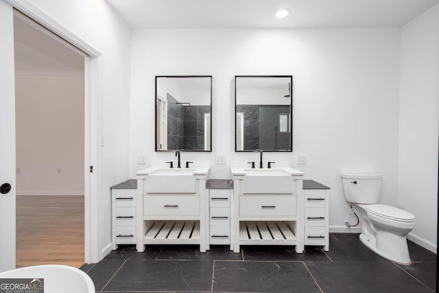 5491 Hiram Rd, Powder Springs, GA 30127 - bathroom featuring two vanities, a tile shower, a freestanding tub, and recessed lighting
