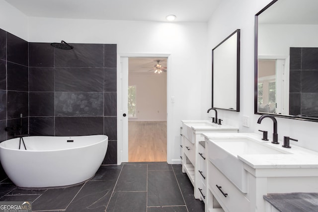 5491 Hiram Rd, Powder Springs, GA 30127 - full bathroom with a soaking tub, two vanities, plenty of natural light, and ceiling fan