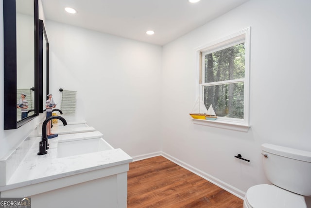 5491 Hiram Rd, Powder Springs, GA 30127 - bathroom with vanity, wood finished floors, and recessed lighting