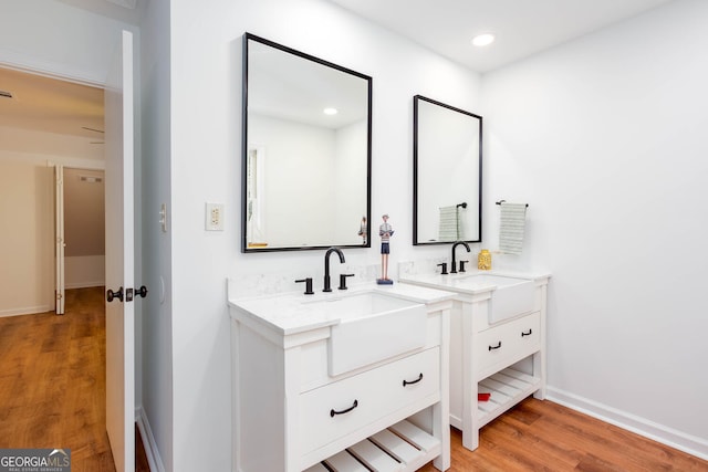 5491 Hiram Rd, Powder Springs, GA 30127 - full bath with wood finished floors, two vanities, and recessed lighting