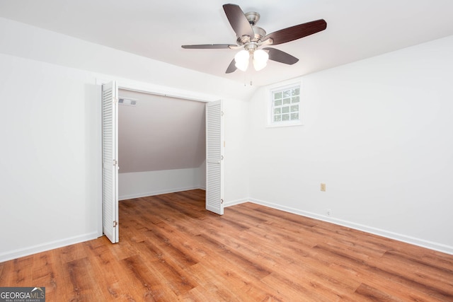 5491 Hiram Rd, Powder Springs, GA 30127 - empty room with light wood-style floors, a ceiling fan, and vaulted ceiling