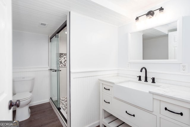 5491 Hiram Rd, Powder Springs, GA 30127 - bathroom with vanity, wainscoting, a shower stall, wood finished floors, and crown molding