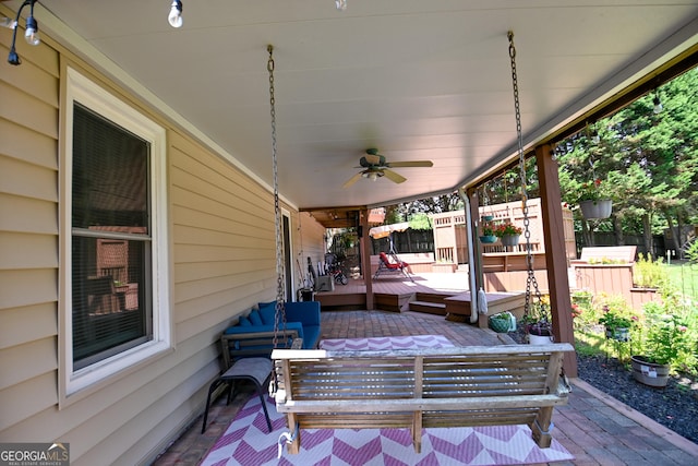 432 Nicole Ct, Winder, GA 30680 - deck featuring ceiling fan, an outdoor living space, and a patio area