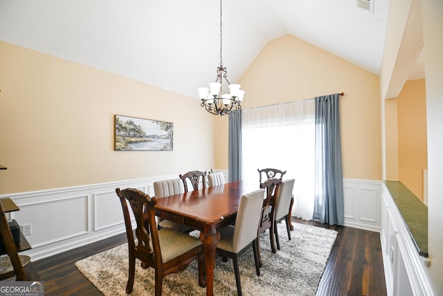 432 Nicole Ct, Winder, GA 30680 - dining area with a chandelier, dark wood-style floors, wainscoting, a decorative wall, and lofted ceiling