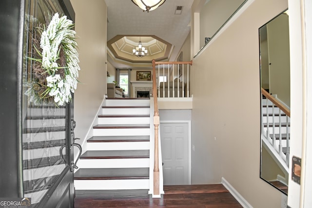 432 Nicole Ct, Winder, GA 30680 - stairway with a tray ceiling, wood finished floors, and a chandelier