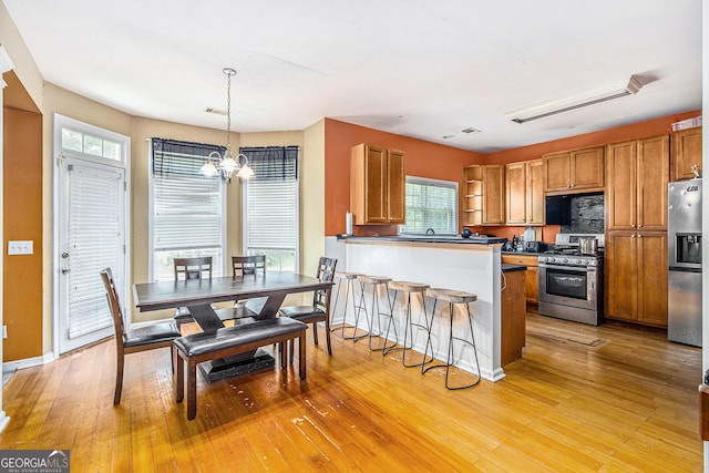 485 Greyhawk Way, Fairburn, GA 30213 - kitchen featuring appliances with stainless steel finishes, a chandelier, and brown cabinetry