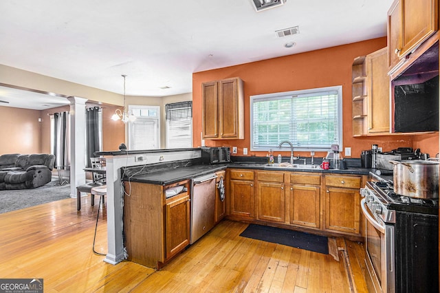 485 Greyhawk Way, Fairburn, GA 30213 - kitchen featuring appliances with stainless steel finishes, brown cabinetry, a peninsula, and dark countertops