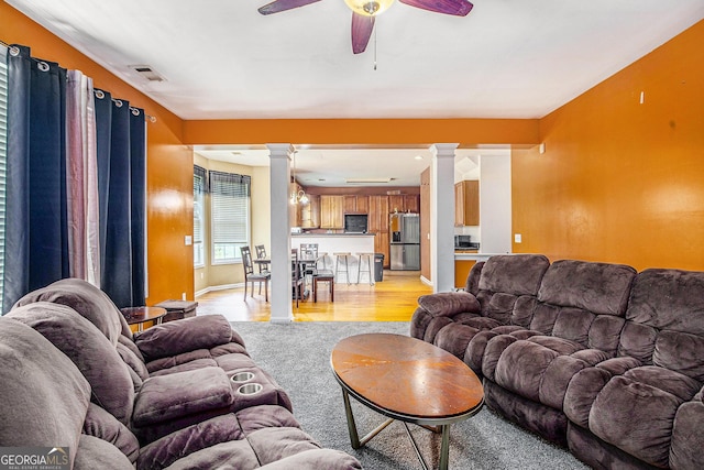 485 Greyhawk Way, Fairburn, GA 30213 - living area with decorative columns, a ceiling fan, and light wood-style flooring