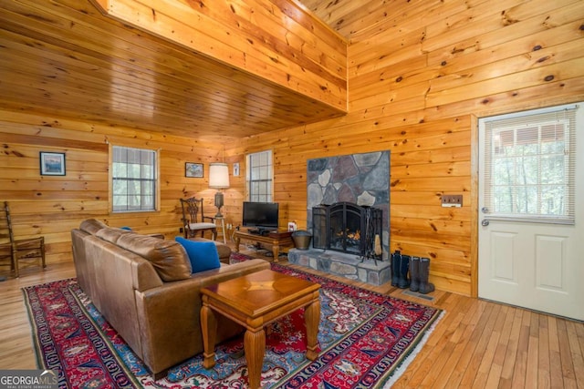 71 Cohutta Forest Rd Unit 9, Chatsworth, GA 30705 - living room with a stone fireplace, wooden walls, light wood-type flooring, and wood ceiling