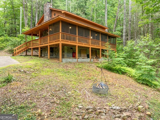 71 Cohutta Forest Rd Unit 9, Chatsworth, GA 30705 - rustic home with a fire pit, a sunroom, a wooded view, a chimney, and a wooden deck