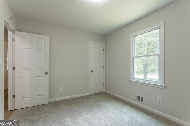 356 Waterway Trl, Powder Springs, GA 30127 - unfurnished bedroom featuring multiple windows and light colored carpet