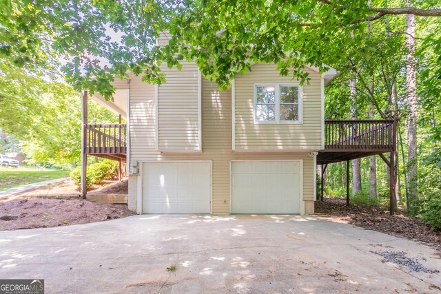 356 Waterway Trl, Powder Springs, GA 30127 - view of front facade with an attached garage, a deck, and concrete driveway