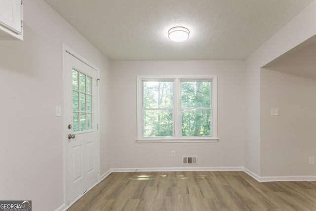 356 Waterway Trl, Powder Springs, GA 30127 - doorway to outside with light wood finished floors and a textured ceiling