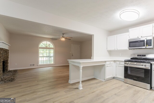 356 Waterway Trl, Powder Springs, GA 30127 - kitchen featuring stainless steel appliances, a peninsula, light wood-type flooring, and white cabinets