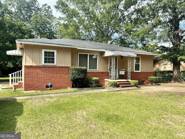 708 Princess Ave, Fort Valley, GA 31030 - bungalow with brick siding, a front lawn, roof with shingles, and crawl space