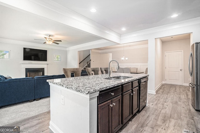 154 Laurel Cove Dr, Hoschton, GA 30548 - kitchen featuring freestanding refrigerator, open floor plan, black dishwasher, light stone countertops, and a kitchen island with sink