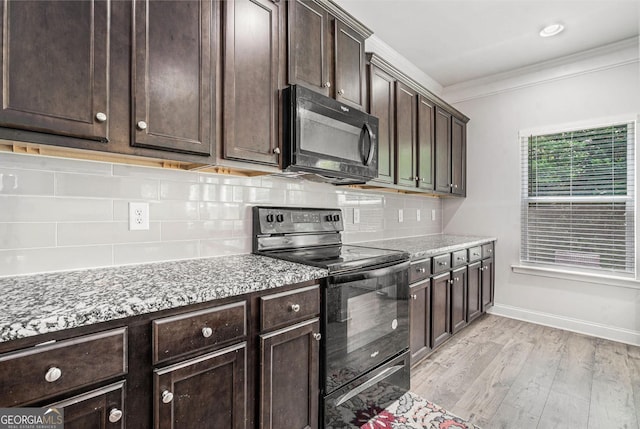 154 Laurel Cove Dr, Hoschton, GA 30548 - kitchen with black appliances, ornamental molding, dark brown cabinets, decorative backsplash, and light wood-type flooring