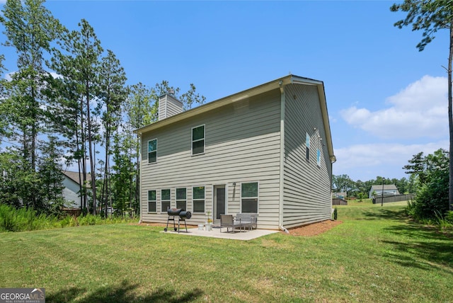 154 Laurel Cove Dr, Hoschton, GA 30548 - back of property with a patio, a yard, and a chimney