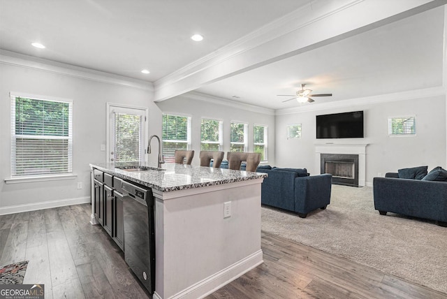 154 Laurel Cove Dr, Hoschton, GA 30548 - kitchen with dishwasher, light stone counters, a premium fireplace, an island with sink, and ornamental molding