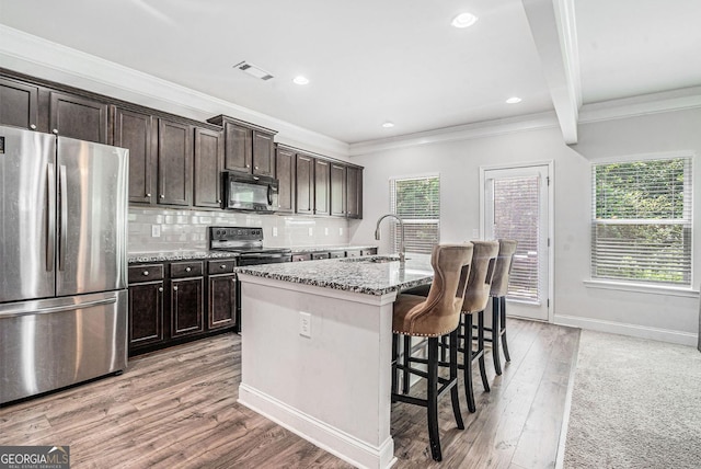 154 Laurel Cove Dr, Hoschton, GA 30548 - kitchen featuring freestanding refrigerator, black microwave, electric range oven, healthy amount of natural light, and ornamental molding