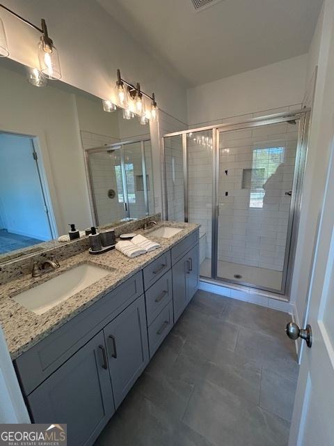 322 Heron St, Ball Ground, GA 30107 - bathroom featuring double vanity, a stall shower, and tile patterned floors