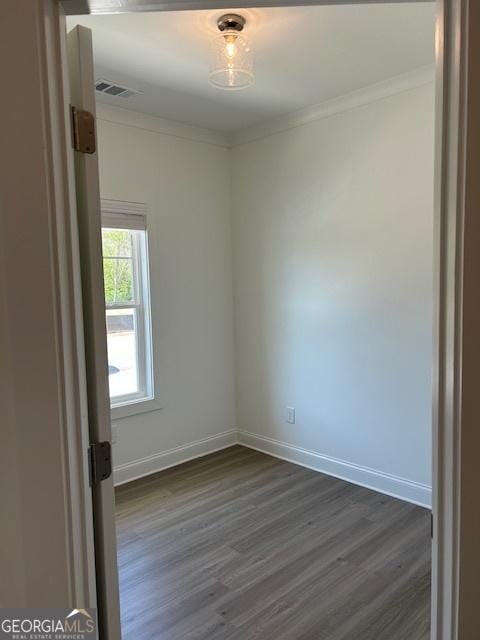 322 Heron St, Ball Ground, GA 30107 - spare room featuring dark wood-type flooring and ornamental molding
