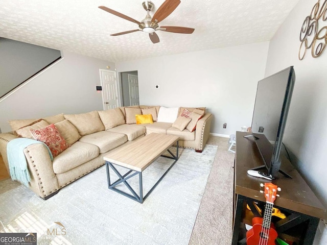 5553 Strathmoor Manor Cir, Lithonia, GA 30058 - living room with a ceiling fan, carpet, and a textured ceiling